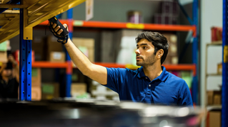 Employee scanning barcode with handheld